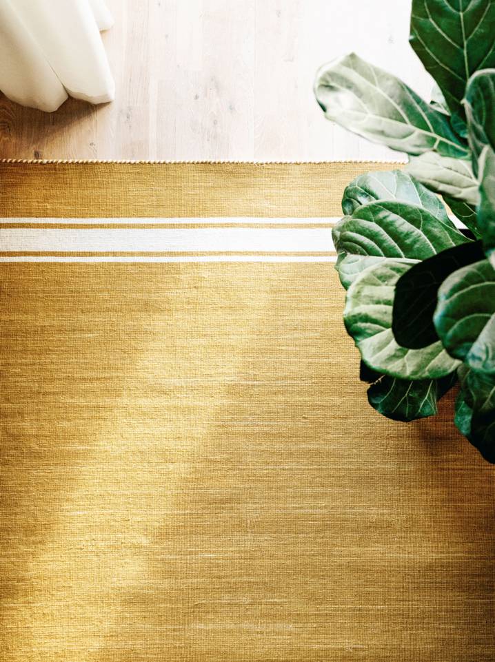 Brown / yellow  röllakan / dhurrie -  Carpet in a dining area.