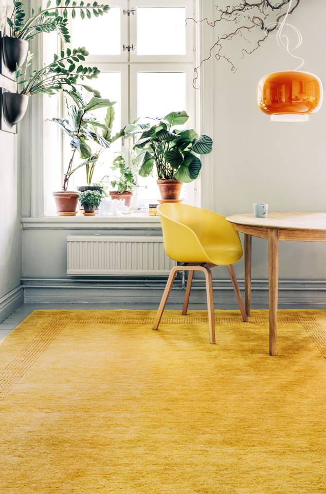 Brown / yellow  handloom -  Carpet in a living room.