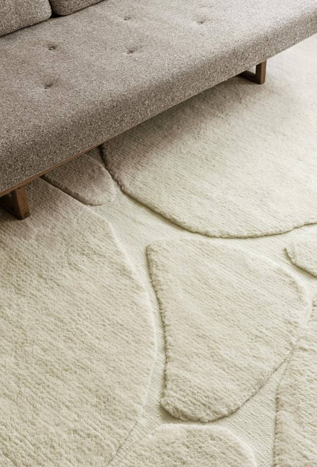 White  high & low handknotted wool -  Carpet in a living room.