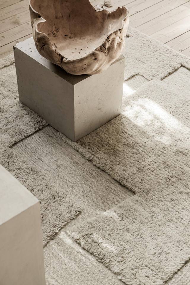 White  high & low handknotted wool -  Carpet in a living room.