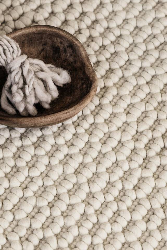 White  handloom -  Carpet in a living room.