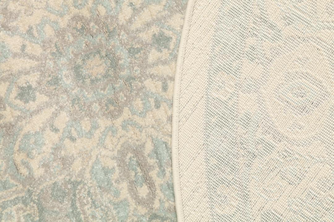 Rond tapijt in crème, beige en lichtblauwe tinten