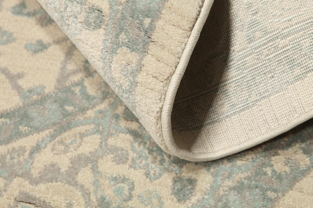 Rond tapijt in crème, beige en lichtblauwe tinten