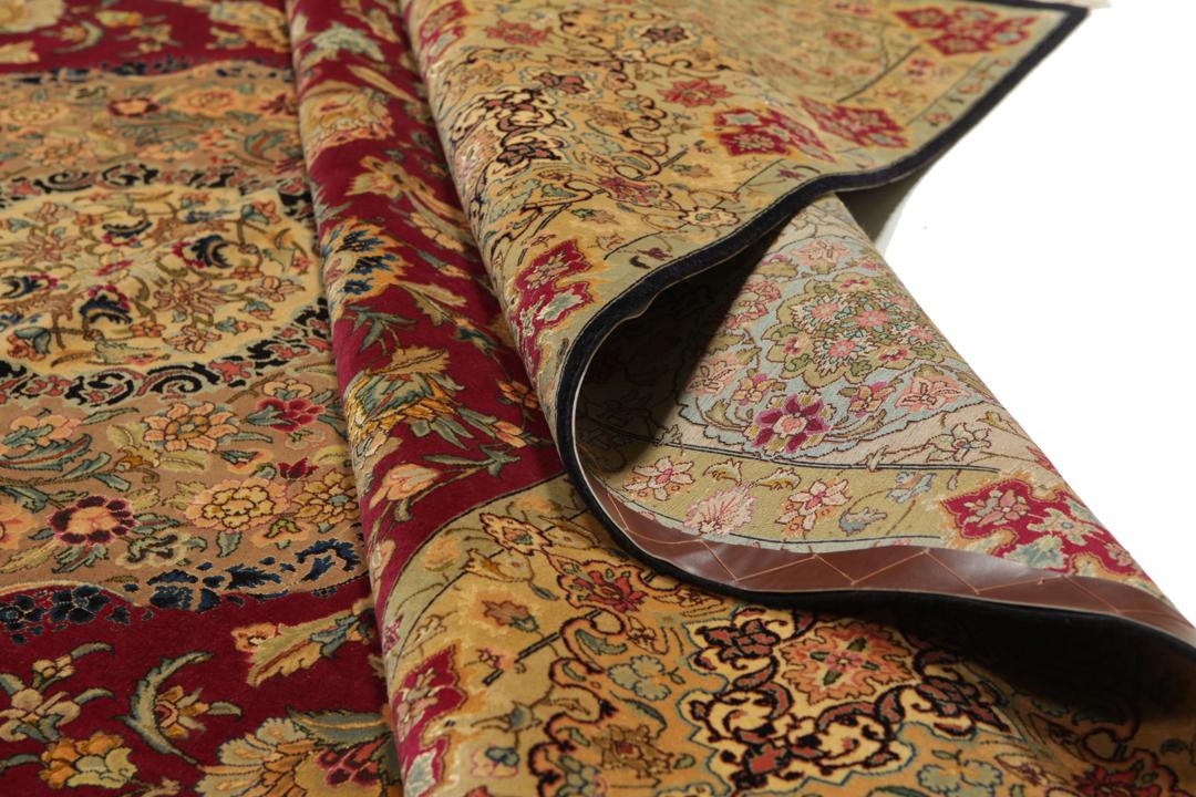 Hand-knotted Tabriz rug from the Middle East featuring a vibrant red field and intricate floral patterns.