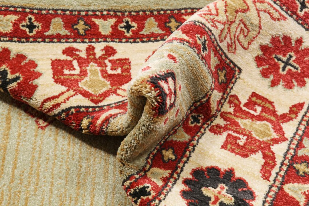 Lichtgroen en crèmekleurig beige vloerkleed met geometrisch patroon
