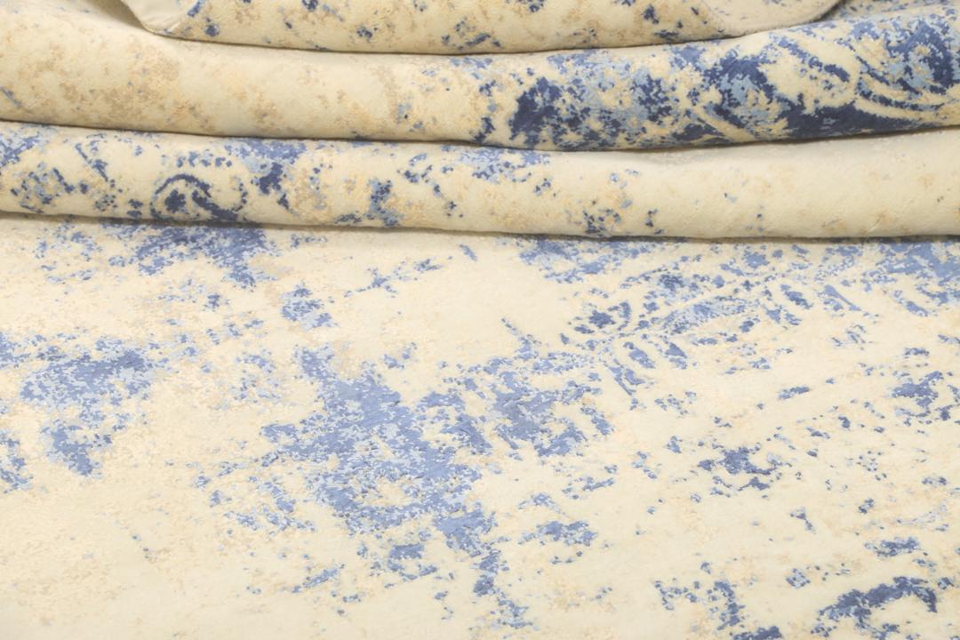Moderne designs tæppe fra Indien i blå og cremede toner