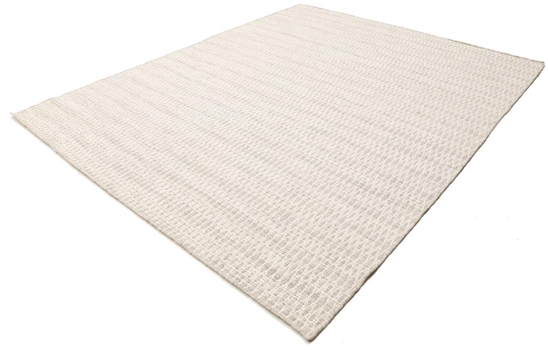 Beige tæppe med et struktureret vævet mønster