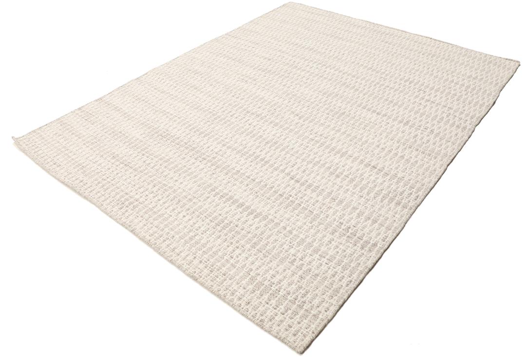 Beige tæppe med et struktureret vævet mønster