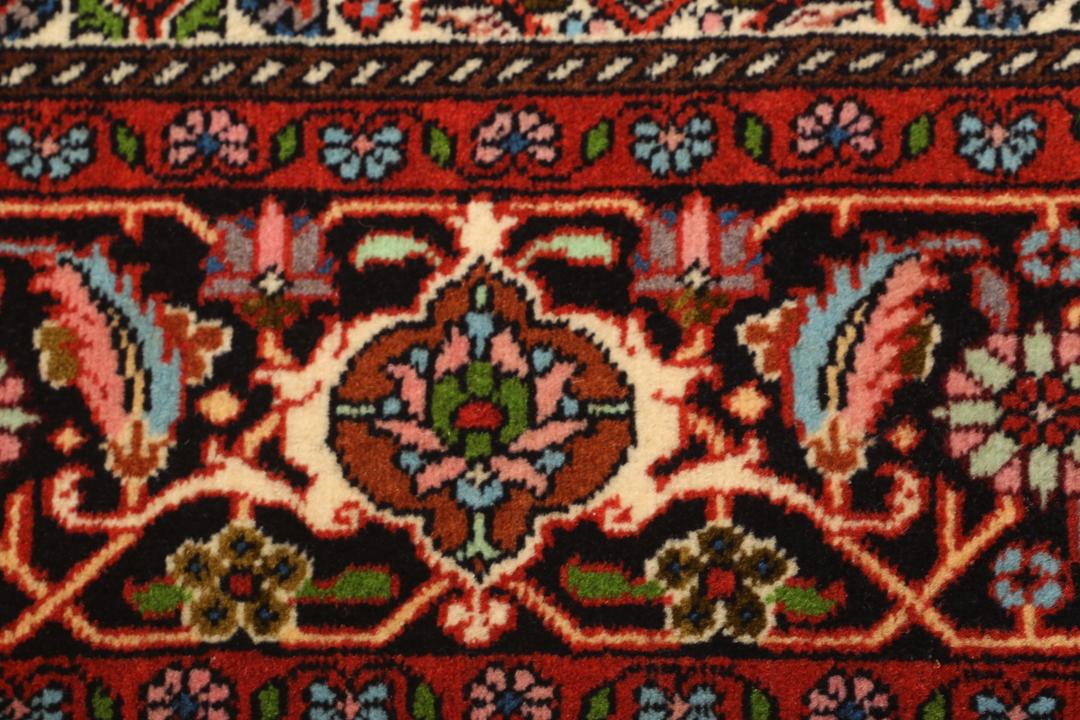 A hand-knotted Bidjar rug from the Middle East in vibrant red and cream tones