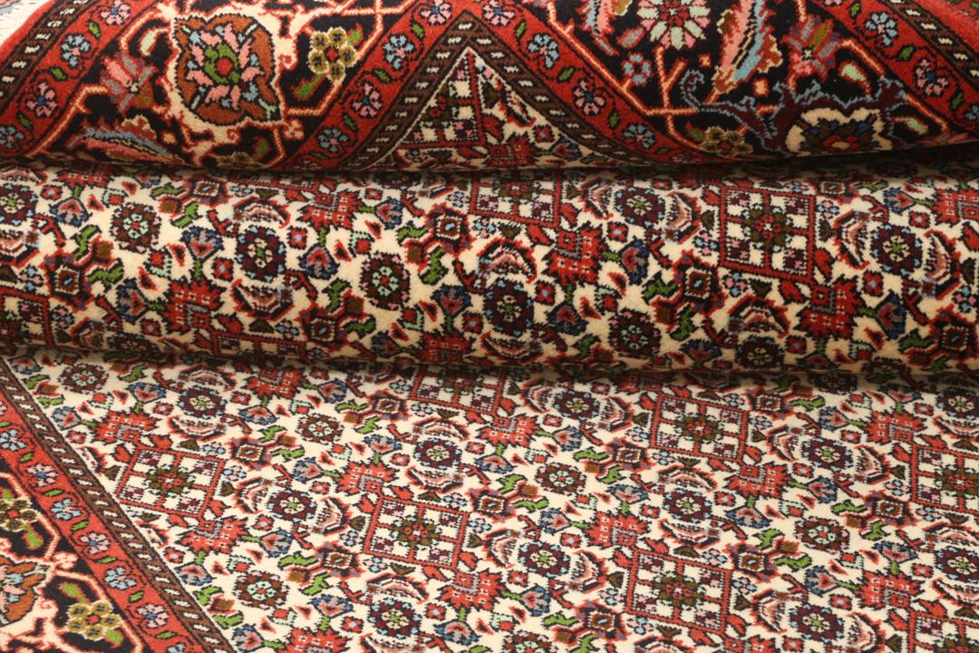 A hand-knotted Bidjar rug from the Middle East in vibrant red and cream tones