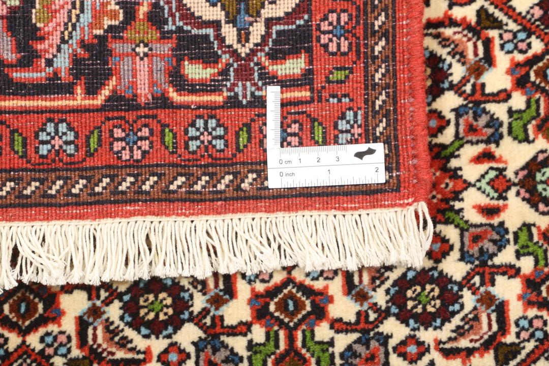 A hand-knotted Bidjar rug from the Middle East in vibrant red and cream tones