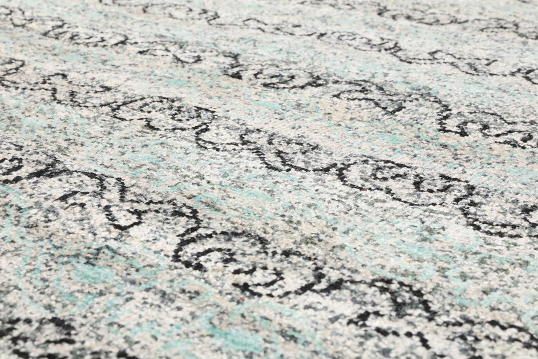 Un tapis gris sophistiqué avec des motifs complexes et un velours en soie douce.