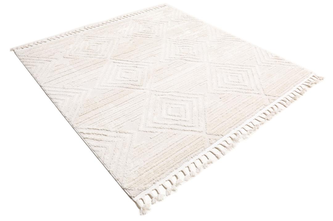 Cream white rug with diamond relief pattern and fringe detail