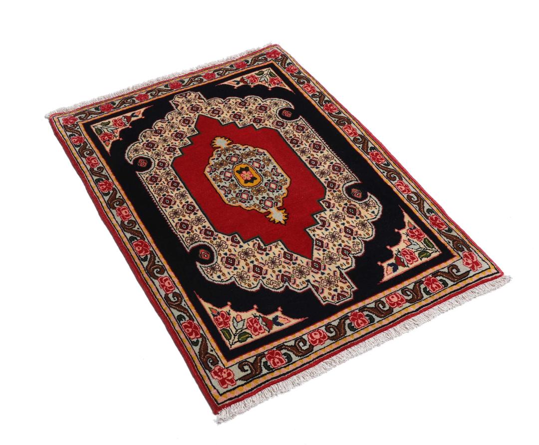 A hand-knotted Senneh rug from the Middle East featuring a vibrant red and black colour palette.