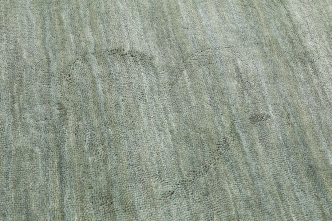 Lysegrønt rundt tæppe med luv
