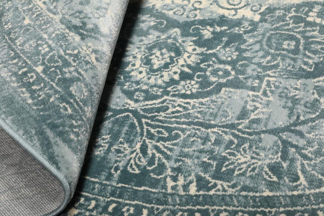 Tapis rond bleu clair avec motif détaillé