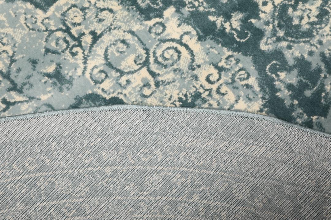 Tapis rond bleu clair avec motif détaillé