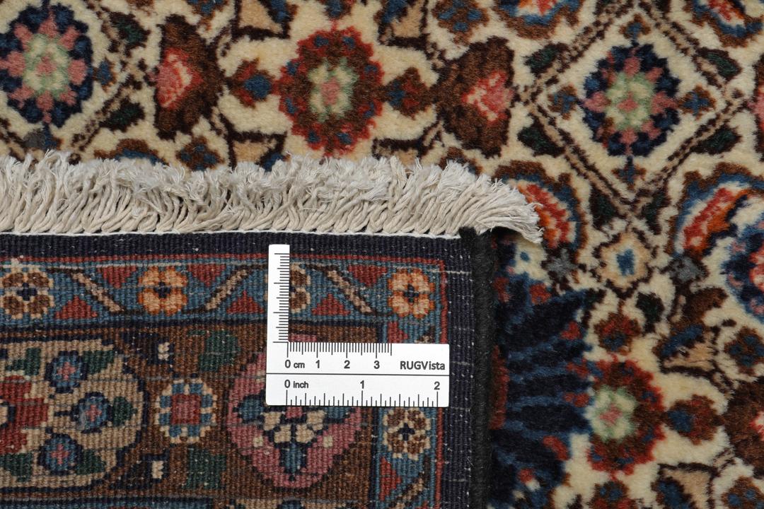 A large rectangular Moud rug from the Middle East featuring a dark-red and beige floral medallion design.