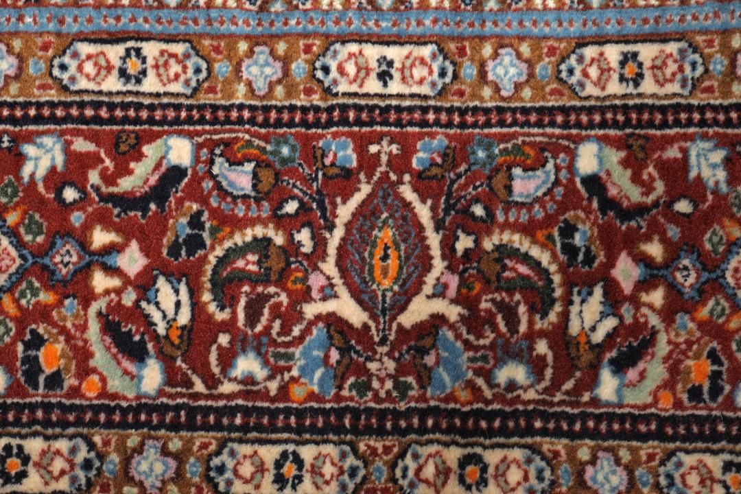 Hand-knotted Moud rug with a central medallion and ornate floral patterns in dark-red and blue