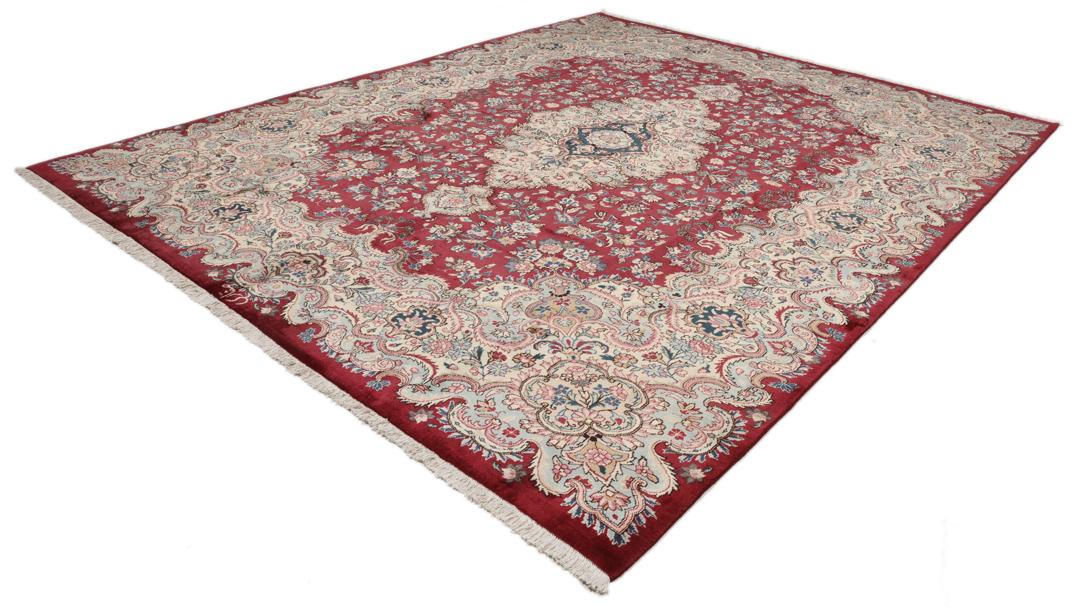 Hand-knotted Mashad rug from the Middle East featuring a dark-red field with intricate floral patterns.