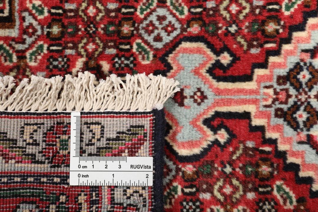Handgeknoopt Senneh-kleed uit het Midden-Oosten in donkerrode en zwarte tinten