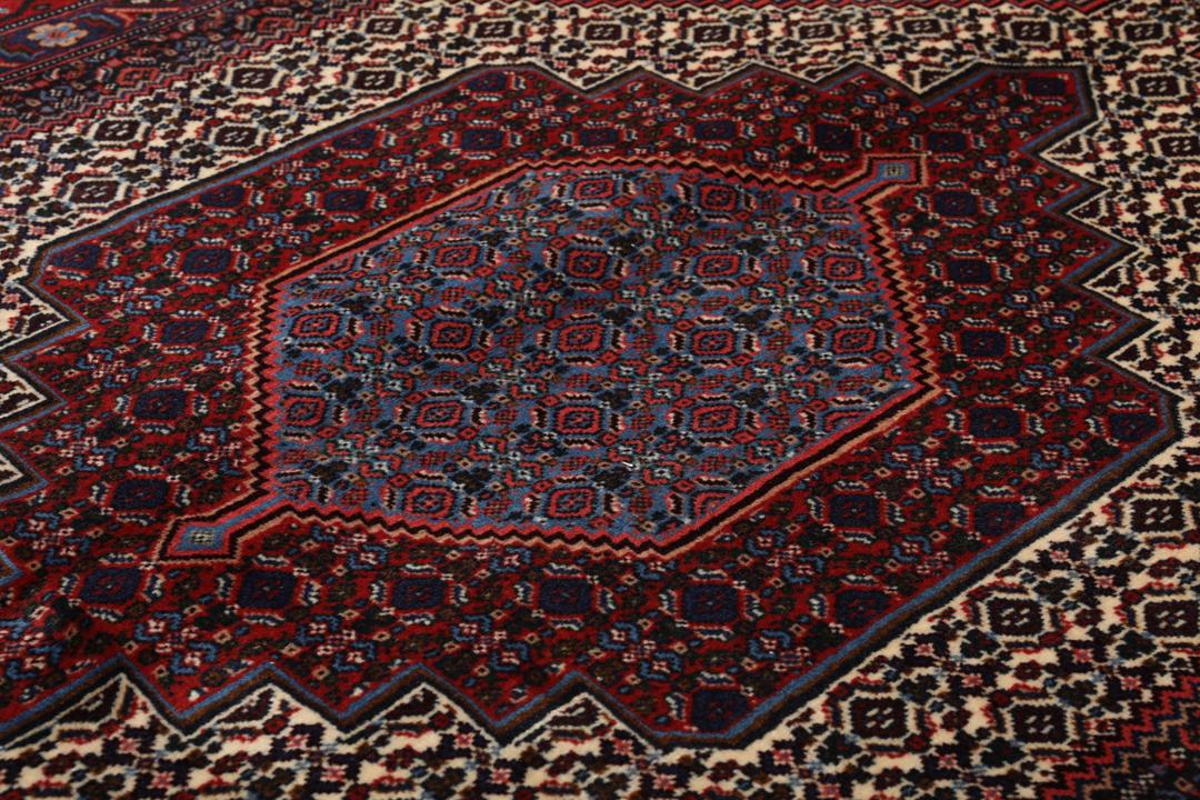Hand-knotted Senneh rug from the Middle East in dark-red and blue tones