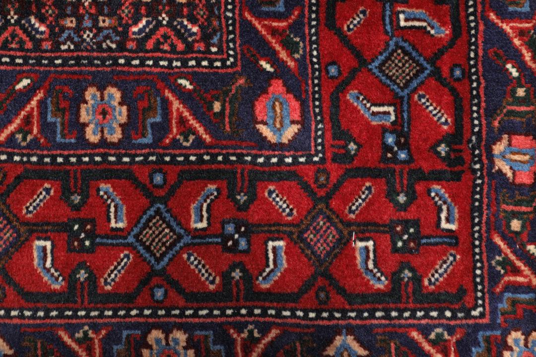 Hand-knotted Senneh rug from the Middle East in dark-red and blue tones