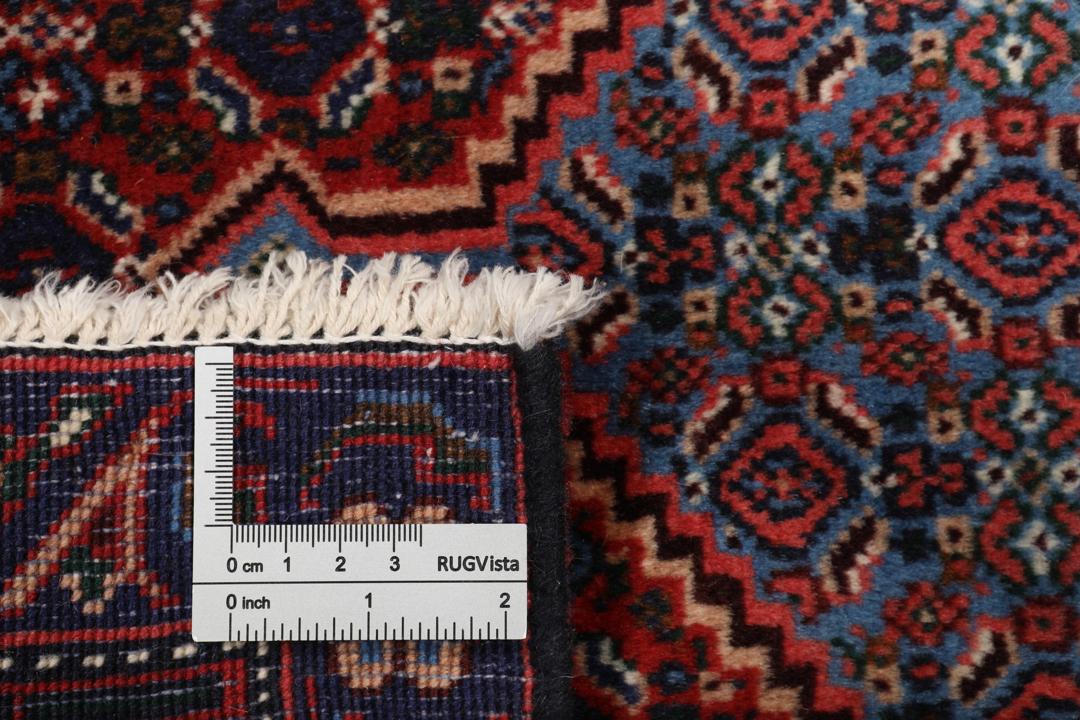 Hand-knotted Senneh rug from the Middle East in dark-red and blue tones