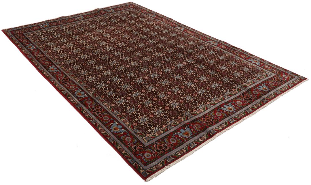 A hand-knotted Senneh rug from the Middle East featuring a dark-red field with geometric motifs.