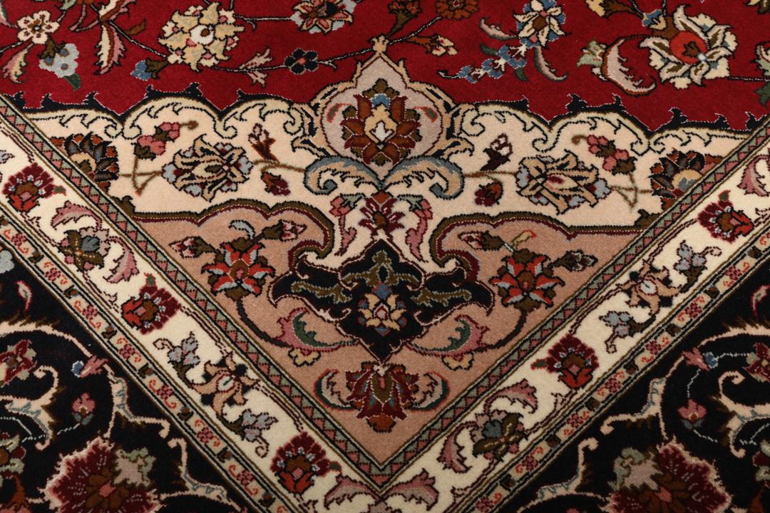 Een vierkant handgeknoopt Tabriz tapijt met een rood veld en een centraal medaillon uit het Midden-Oosten