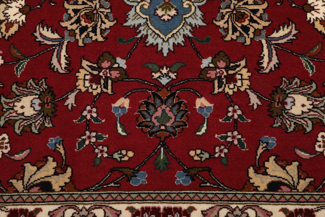 Een vierkant handgeknoopt Tabriz tapijt met een rood veld en een centraal medaillon uit het Midden-Oosten
