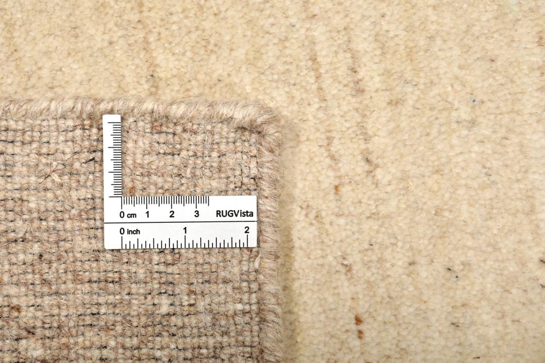 A rectangular rug in natural white and beige with a simple border design.