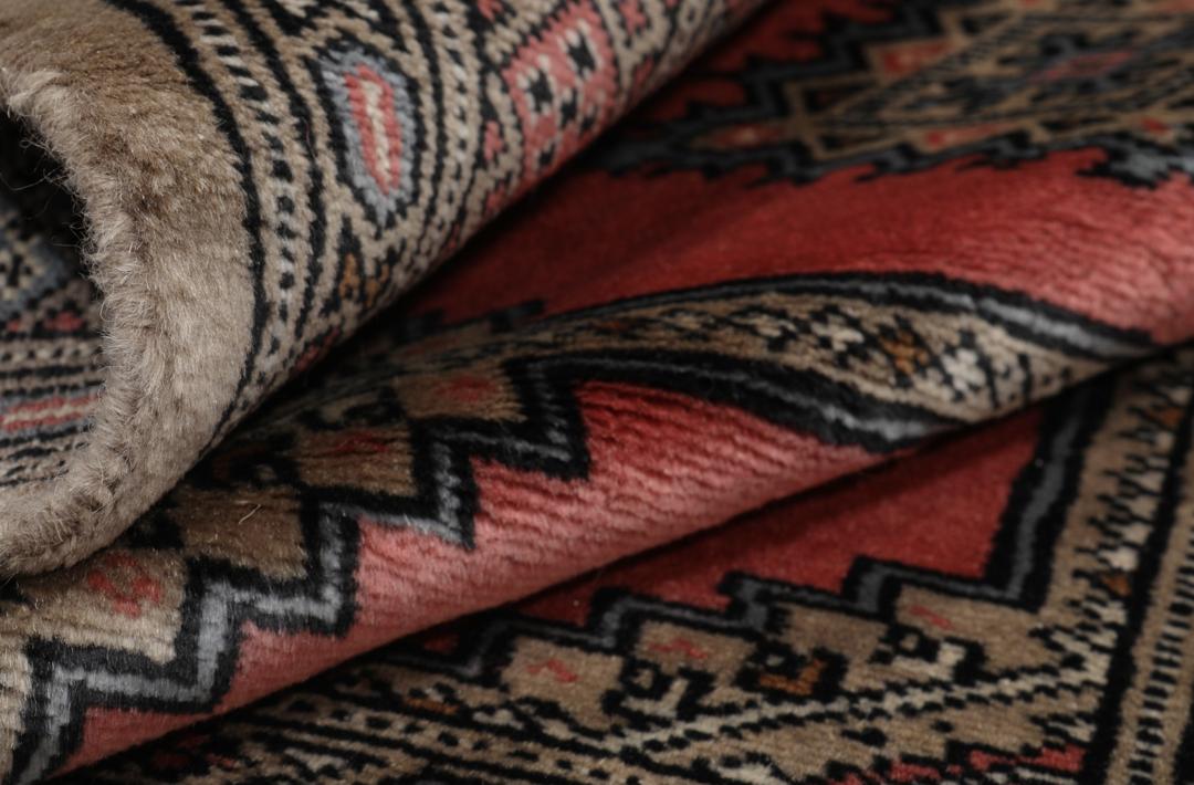 Hand-knotted Pakistan Bokhara 2ply rug in red with medallion motifs