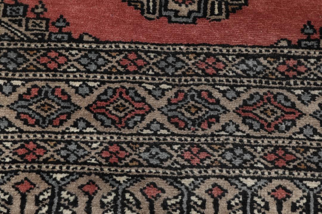 Hand-knotted Pakistan Bokhara rug with a red and beige geometric pattern