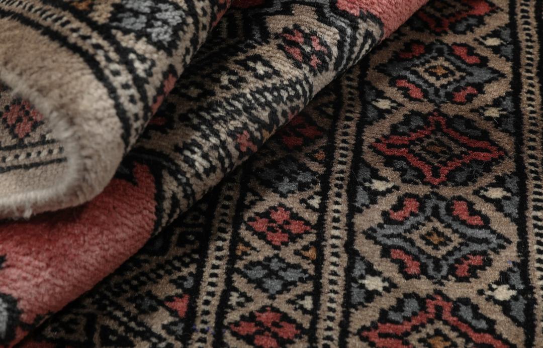 Hand-knotted Pakistan Bokhara rug with a red and beige geometric pattern