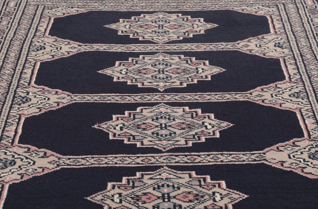 Hand-knotted rug from Pakistan with dark-blue and pink detailing