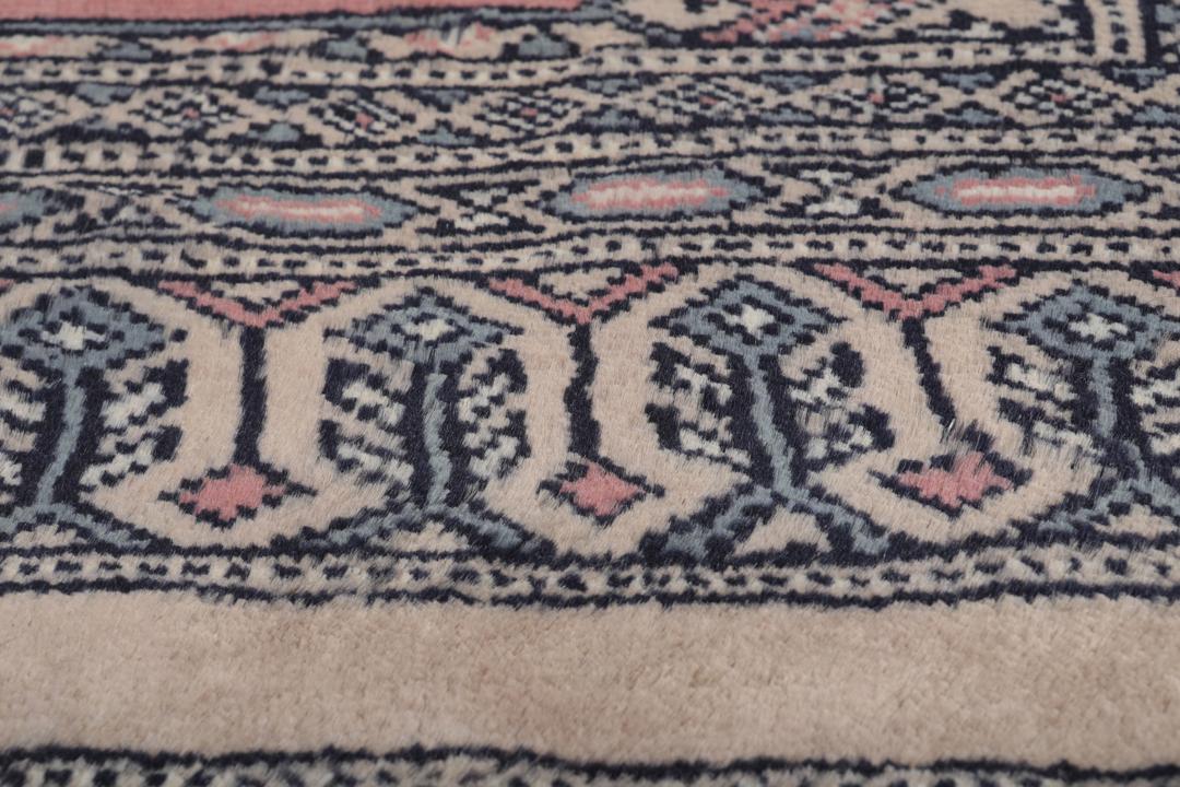 Hand-knotted rug from Pakistan with dark-blue and pink detailing