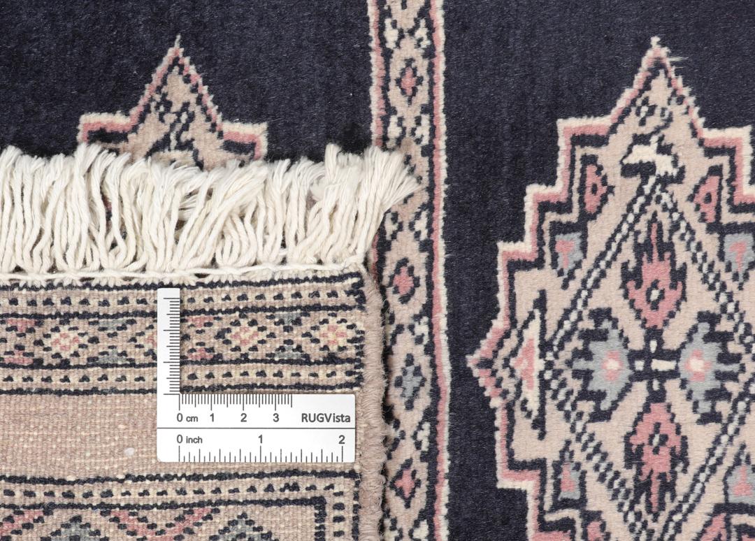Hand-knotted rug from Pakistan with dark-blue and pink detailing