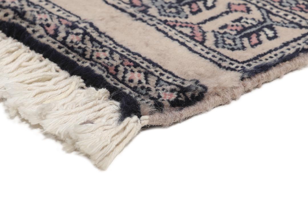 Hand-knotted rug from Pakistan with dark-blue and pink detailing