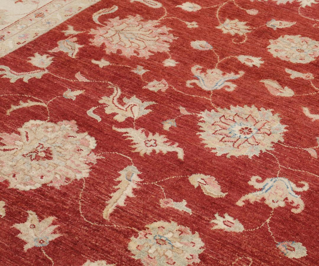 Hand-knotted Afghan rug with floral motifs in dark-red and beige