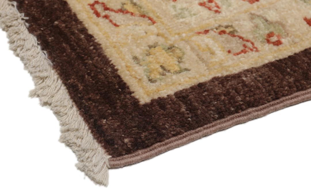 A hand-knotted Afghan rug with a dark brown field and ornate floral patterns.