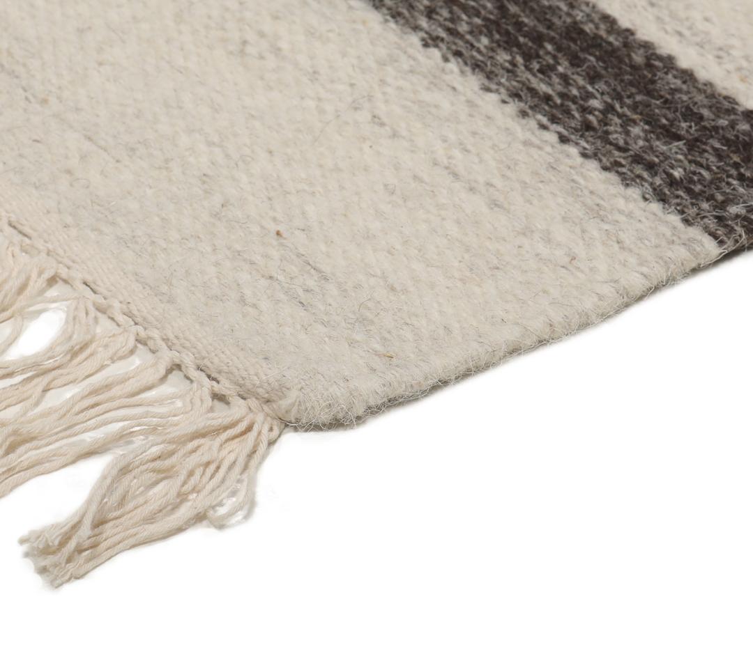 beige uldtæppe