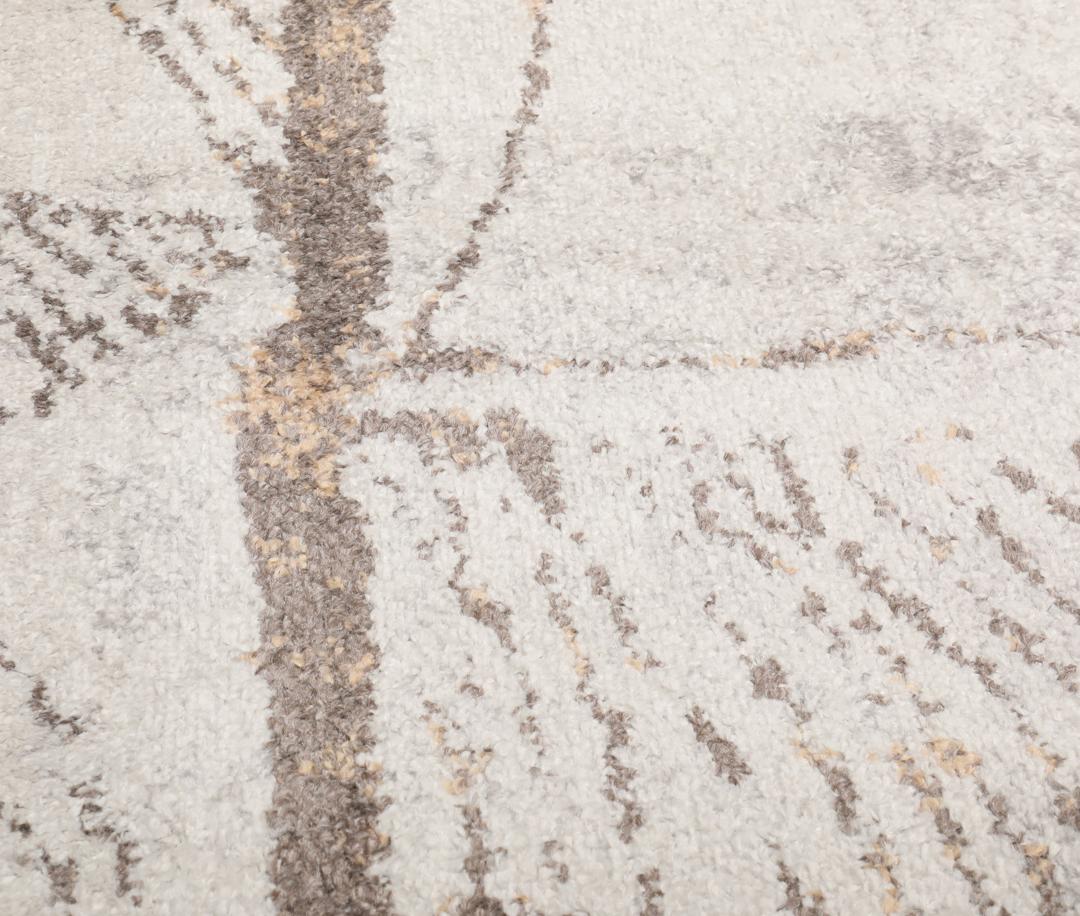 Beige en taupe vloerkleed met geometrische patronen