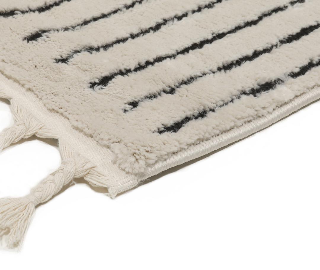 Cream white rug with black geometric lines and fringe