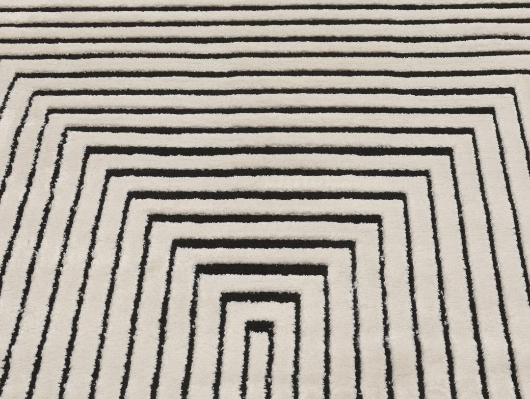 Cream white rug with black geometric lines and fringe