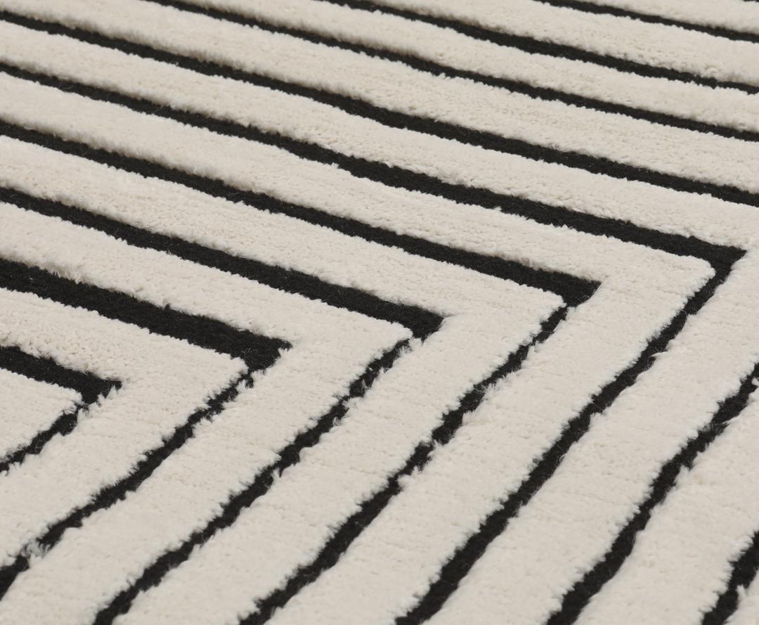 Cream white rug with black geometric lines and fringe