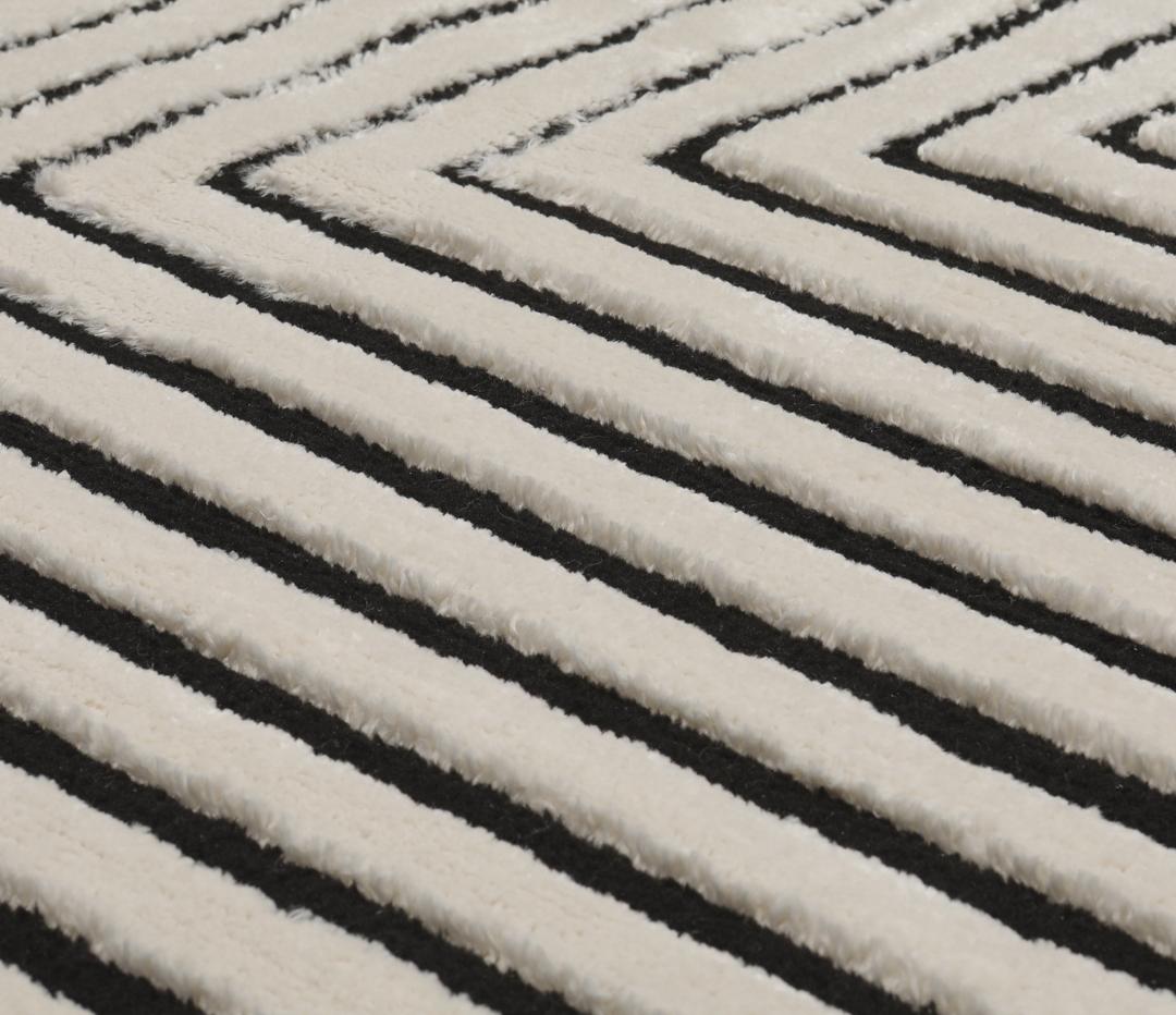 Cream white rug with black geometric lines and fringe