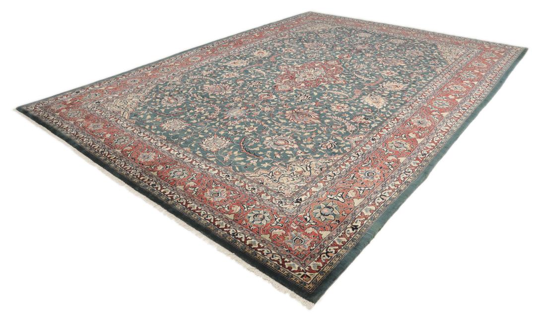A hand-knotted Middle Eastern Sarough rug with a dark-blue field and floral patterns.