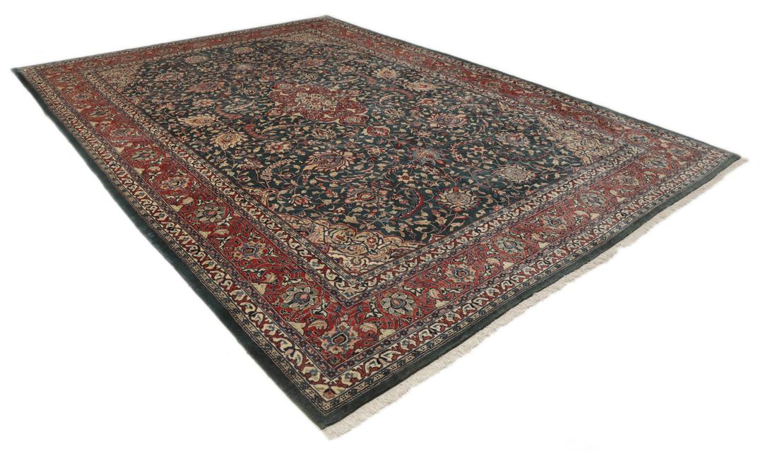 A hand-knotted Middle Eastern Sarough rug with a dark-blue field and floral patterns.