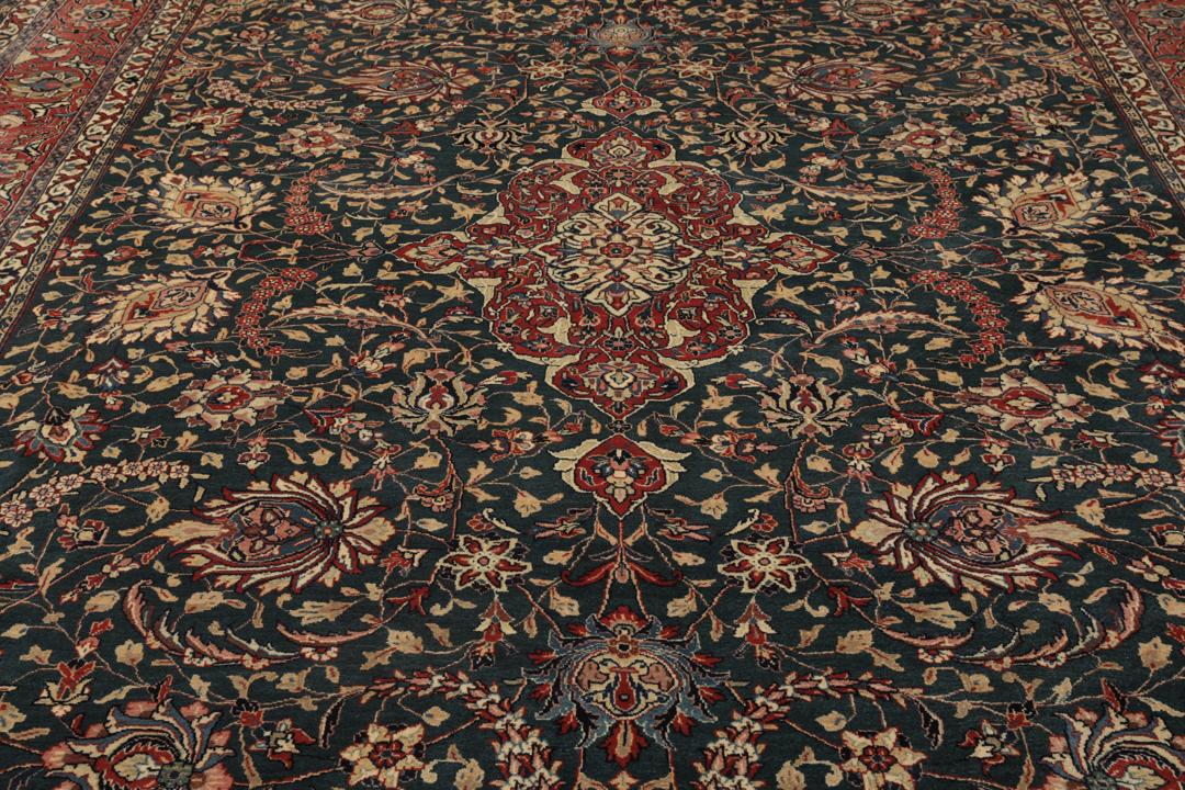 A hand-knotted Middle Eastern Sarough rug with a dark-blue field and floral patterns.